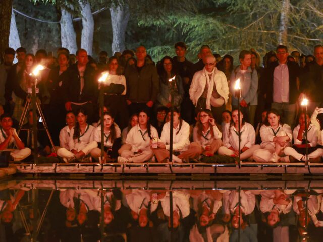 Israeli scouts light torches during a Memorial Day commemoration for fallen soldiers, or Y