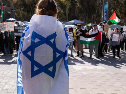 SAN DIEGO, CALIFORNIA - MAY 5: Pro-Israel women, wrapped with an Israeli flag, attends a c