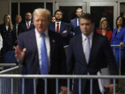 Sen. J.D. Vance (R-OH) and Eric Trump look on as former President Donald Trump speaks to t