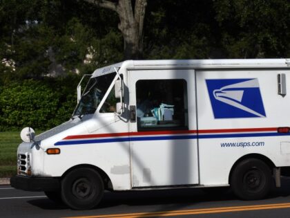 A mail carrier begins his route in a delivery truck on August 17, 2020, in Orlando, Florid