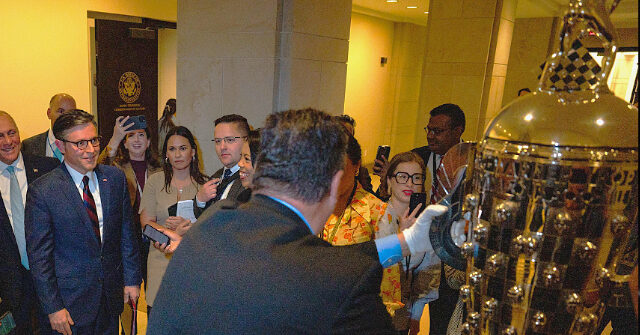 Mike Johnson, Instead of Working for Republicans, Celebrates Giant Trophy Being Brought into Congress