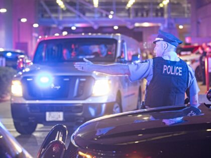 MINNEAPOLIS, MINNESOTA, UNITED STATES - MAY 30: A police officer guides a van that was pre