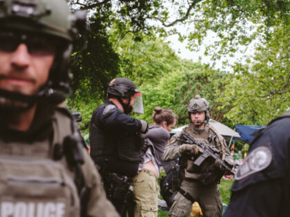 CHARLOTTESVILLE, VIRGINIA - MAY 04: Heavily armed police arrests a protester on university