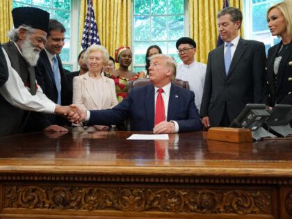 U.S. President Donald Trump shakes hands with Abdul Shakoor, an Ahmadiyya Muslim from Paki