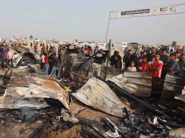 Palestinians gather at the site of an Israeli strike on a camp for internally displaced pe