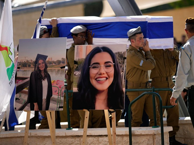 MODI'IN-MACCABIM-RE'UT, ISRAEL - NOVEMBER 17: Soldiers carry the coffin of Noa Marciano, a soldier in the Israel Defense Forces, as they walk near photos of her displayed at her funeral on November 17, 2023 at a cemetery in Modi'in-Maccabim-Re'ut, Israel. Marciano, a 19-year-old soldier who served in the Combat Intelligence Collection Corps of the 414th Regiment, was captured by Hamas fighters during their Oct. 7 attack and taken back to Gaza. The Israeli military announced her death earlier this week. (Photo by Christopher Furlong/Getty Images)