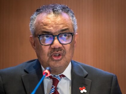 World Health Organization (WHO) Director-General Tedros Adhanom Ghebreyesus (R) delivers h
