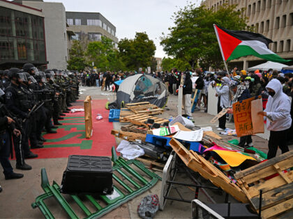 Pro-Palestinian demonstrators confront police as they clear an encampment after students o