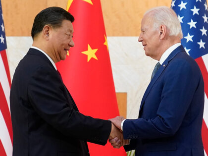 U.S. President Joe Biden, right, and Chinese President Xi Jinping shake hands before their