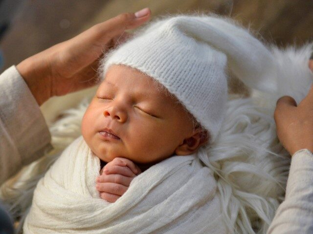 Fanny Nurdiana, a female photographer, works during a photo session of a newborn baby in B