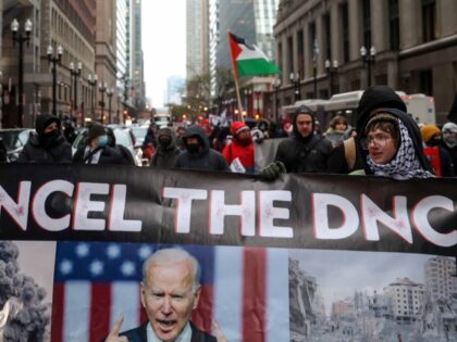 Demonstrators march in protest of the City of Chicago's plan to host the upcoming 202