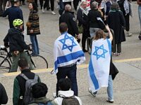 Cambridge, MA - May 3: Two people wearing Israel flags walk through the MIT campus and pro