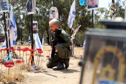 An Israeli soldier mourns at a memorial for people taken hostage or killed in Hamas's atta