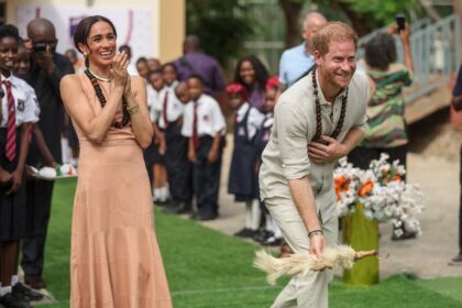 Britain's Prince Harry and his wife Meghan visit a school in Abuja to open an event on men