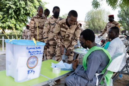 Chadian soldiers get ready to vote in an outdoor polling station in N'Djamena