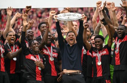 Champions: Bayer Leverkusen coach Xabi Alonso and his players celebrate with the Bundeslig