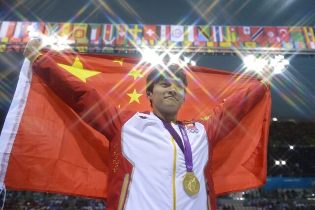 China's Sun Yang poses on the podium with the gold medal for the 1500m freestyle at the Lo