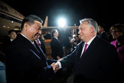 Chinese President Xi Jinping (L) is greeted by Hungarian Prime Minister Viktor Orban (R) a