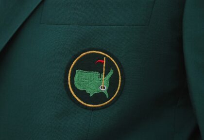 A close-up of a Masters green jacket