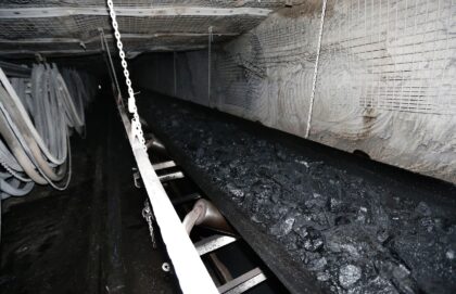 A conveyor belt transports tons of coal at a mine
