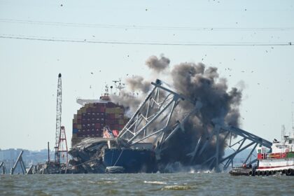 Crews conduct a controlled demolition of a section of the Francis Scott Key Bridge resting