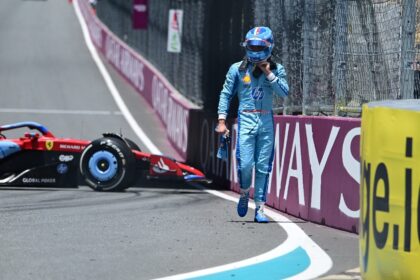 Ferrari's Monegasque driver Charles Leclerc walks off the track after spinning out during