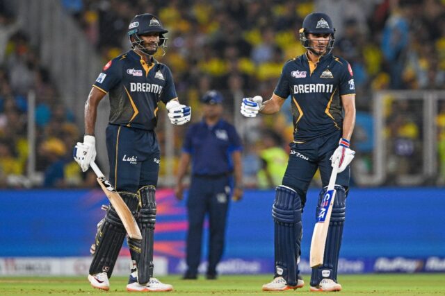 Gujarat Titans' captain Shubman Gill (R) and Sai Sudharsan (L) bump fists during their 210