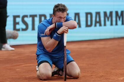 Down and out: Jiri Lehecka kneels on the court prior to retiring against Felix Auger Alias