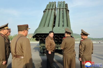 North Korean leader Kim Jong Un inspects the 240mm multiple rocket launcher system at an u