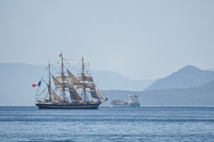 The Olympic flame is being brought to France from Greece on a 19th-century tall ship