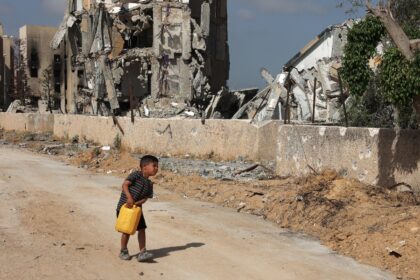 A Palestinian boy carries a water canister in Beit Lahia, the northern Gaza Strip, where t