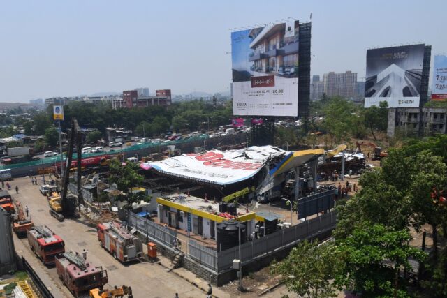 Rescue operations underway after a huge billboard collapsed on a petrol station following