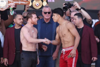 Saul Alvarez and challenger Jaime Munguia shake hands at the weigh-in for their all-Mexica