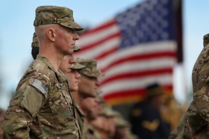 Soldiers bound for Afghanistan stand at parade rest during a departure ceremony on Novembe