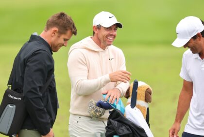 Four-time major winner Rory McIlroy of Northern Ireland shares a smile on the driving rang