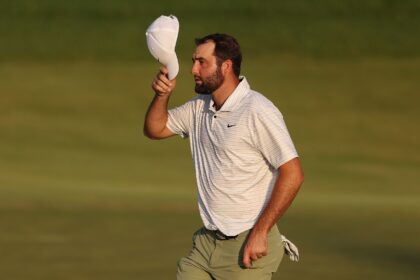 Top-ranked Scottie Scheffler, tipping his cap to fans at the end of his first round of the