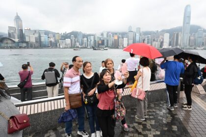 Tourists from mainland China visit the Tsim Sha Tsui waterfront in Hong Kong on May 1, the