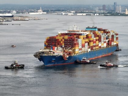 Tug boats maneuver the damaged container ship Dali into the Seagirt Marine Terminal in Bal
