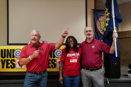 United Auto Workers (UAW) President Shawn Fain, right, celebrates with local organizers at
