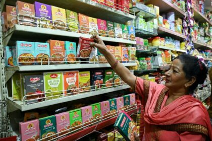 A woman buys spice packets at a store in the Indian city of Amritsar on May 21