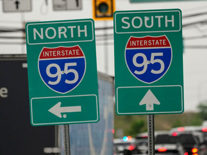 Interstate 95 signs stand near an elevated section that collapsed, in Philadelphia, Monday