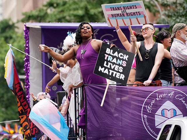 Participants hold signs reading 