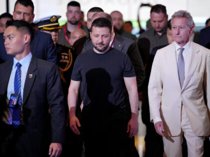Ukraine’s President Volodymyr Zelenskyy, center, arrives at a hotel, the venue of the 21