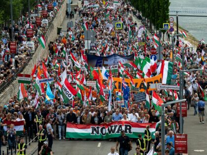 People march during a rally in support of Hungary's Prime Minister Viktor Orbán and his p