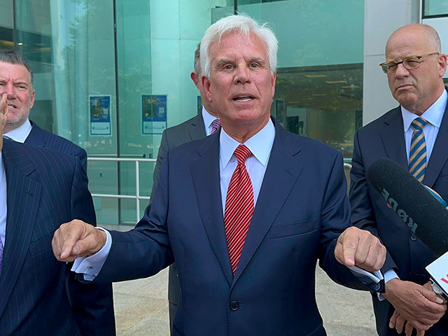 Influential Democratic power broker George Norcross, center, speaks outside the justice co