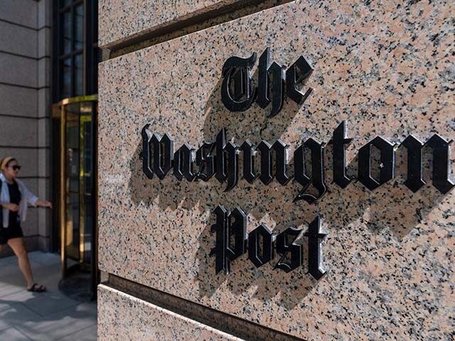 A person walks into the One Franklin Square Building, home of The Washington Post newspape