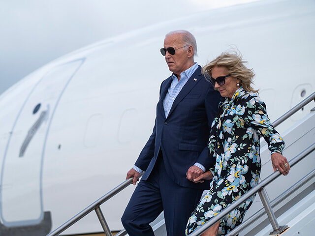 President Joe Biden, left, and first lady Jill Biden arrive at McGuire Air Force Base, Sat