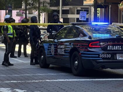Police respond to the scene of a shooting outside the Peachtree Center complex, Tuesday, J