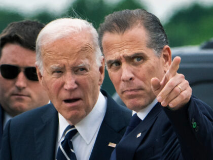 President Joe Biden talks with his son Hunter Biden as …
