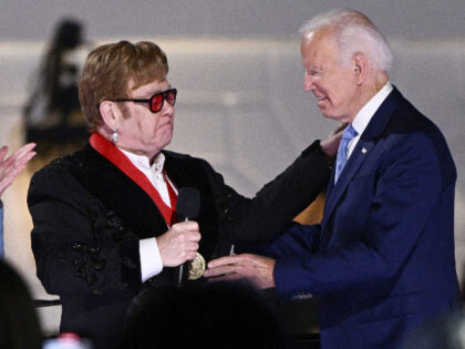 First Lady Jill Biden applauds as British singer Elton John gets emotional while US Presid